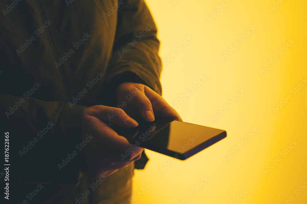 Wall mural woman using smartphone on street at night