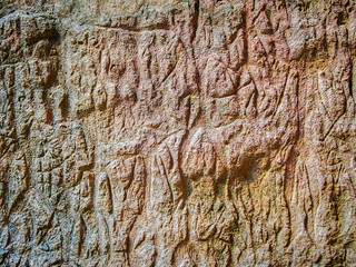 Real rock wall with petroglyphs background  (in the Gobustan National Park, Azerbaijan)