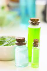 Natural green cosmetics, aromatherapy concept. Essential oil in glass bottles, white background, close up
