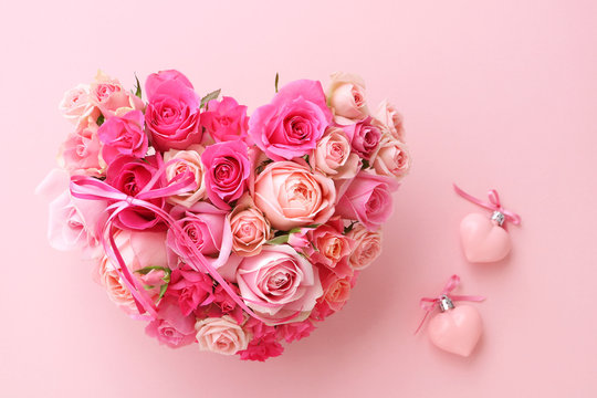 Valentines heart shaped bouquet of beautiful pink rose flowers with heart ornaments 