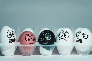 Faces on eggs in the form of facial expressions, reflecting emotions. The concept of racism,...