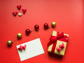 flat lay minimal concept for valentine's day and chinese new year event with gold gift set and greeting card with heart on red background