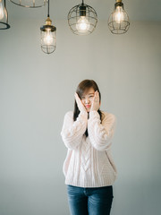 portrait concept from  girl in knitting sweater at workplace and architecture decoration item with...