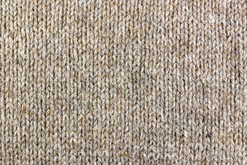 Knitted texture of lama wool closeup. Natural wool fabric background