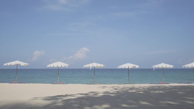 Row of White Umbrellas on Tropical Surin Beach, Phuket, Thailand