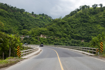 Bridge in Guatemala and green mountains.