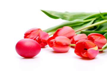 Bunch of flowers near pink Easter egg.