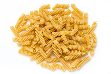 Uncooked fusilli pasta isolated white background.