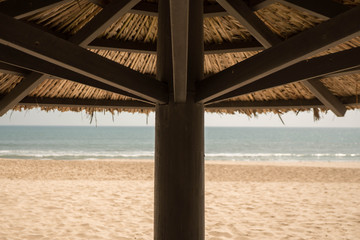 close up of a tropical parasol in the south of Vietnam, south east asia is so lovely, with beach and ocean in the background