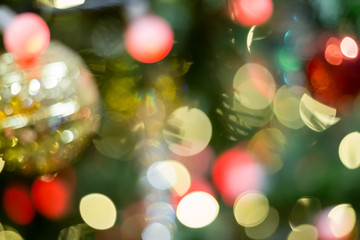 Obraz na płótnie Canvas Colorful Red, Yellow and Green Christmas Tree Bokeh background of de focused glittering lights,