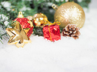 Gold christmas balls and star and red box in the snow. Copy and paste for background,  Concept decoration of christmas