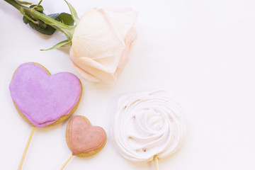 St. Valentine's Day concept with a beautiful white rose and ginger cookies, white background top view