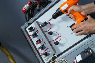 technician at maintenance work with an electric pump