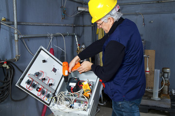 technician at maintenance work with an electric pump