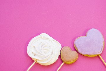 St. Valentine's Day or Anniversary concept with sweets and ginger cookies, pink background, top view