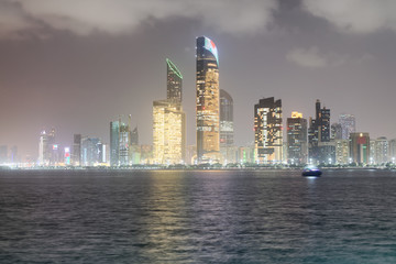 Reflections of Corniche Road buildings at night as seen from Marina, Abu Dhabi