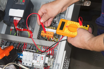 technician at maintenance work with an electric pump