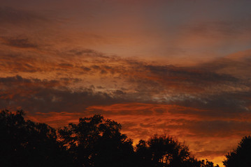 Sunset with clouds that have a red tone of the sun light