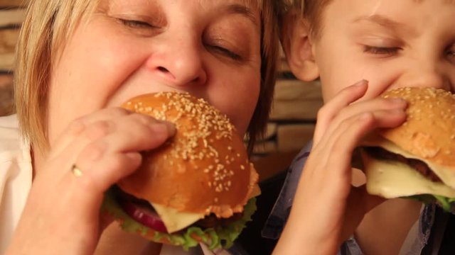 close-up of a family eating hamburgers