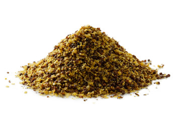 A pile of dry ground brown mustard seeds isolated on white.