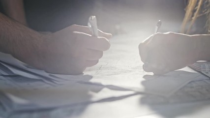 Close-up Of Person's engineer Hand Drawing Plan On Print with architect equipment.