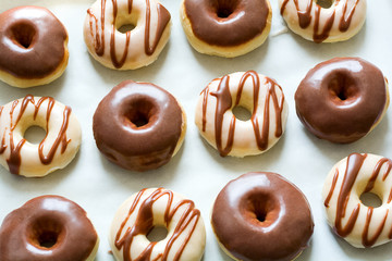 Sweet donuts with chocolate coating. Flat lay. Top view