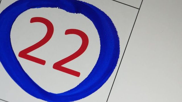 The Blue Marker Circled 22th Red Date On The Calendar
