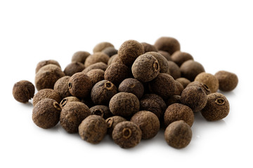 A pile of whole allspice isolated on white. - obrazy, fototapety, plakaty