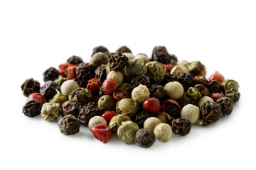 A pile of mixed peppercorns isolated on white.