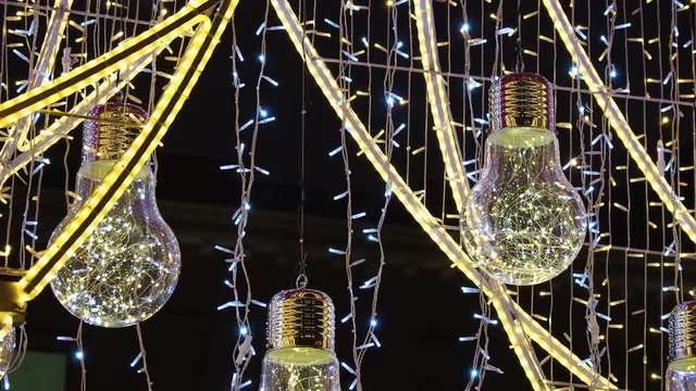 Famous Arbat street decorated for Christmas and New Year celebration. Bottom view on decorative light bulbs. Moscow, Russia.