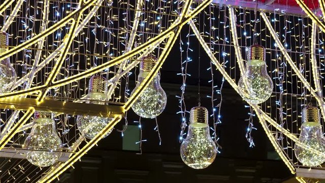 Famous Arbat street decorated for Christmas and New Year celebration. Bottom view on decorative light bulbs. Moscow, Russia.