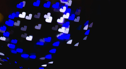 The bokeh of heart shape from the beautiful colourful light decoration at night. place for text.