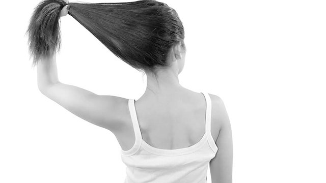 Woman undo ponytail showing long hair smiling isolated