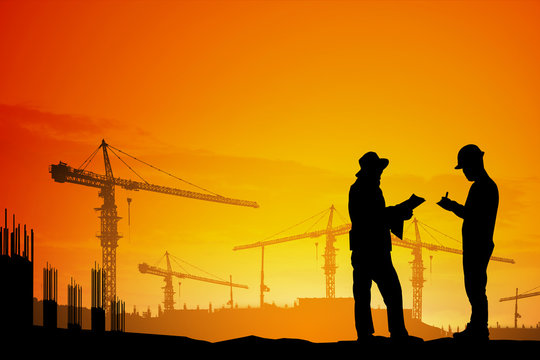 Silhouette engineer standing talking Planner work on construction site  with natural light blurred worker in construction site and nature