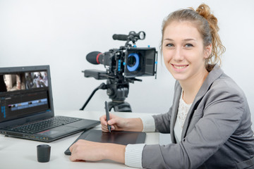 Naklejka premium young woman designer using graphics tablet for video editing
