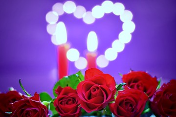  Moody decoration for Valentine's day concept-bouquet of roses and candles on a ultra violet background with heart.