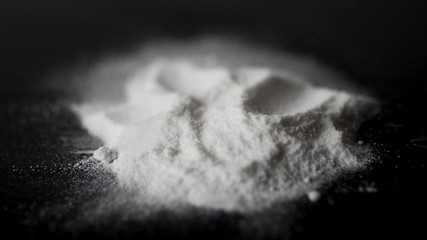 DRUGS: Man does a lines of heroin by plastic card - Close up. Plastic card and white powder. Lines and pile of cocaine on wooden table. Macro - obrazy, fototapety, plakaty