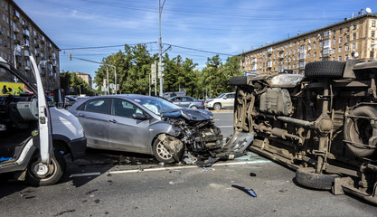 Accident involving an overturned ambulance ranning into a car and rolled over