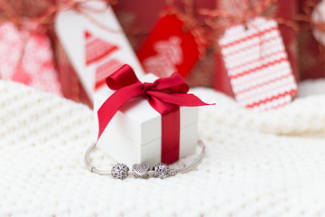 Present boxes. Jewelry. Silver bracelet with charms.