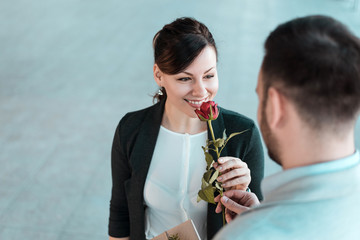 Woman smelling rose given by her boyfriend.