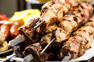 Fresh, hot, fried, appetizing shish kebab cooked on the grill on the coals.