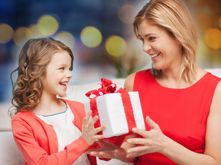 happy mother and daughter with gift box