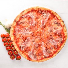 Pizza Lardon. Bacon, cherry tomatoes, sausage salami. On a wooden background. Top view.