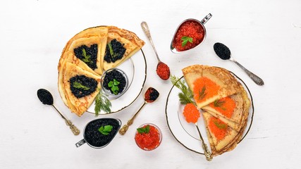 Pancakes with caviar. On a wooden background. Top view. Free space for text.