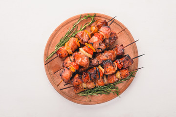 Marinated baked kebab with onions and spices. On a wooden background. Top view. Free space for text.