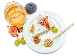 traditional french brie cheese and honey on a white background