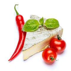 traditional french brie cheese, tomato and pepper on a white background