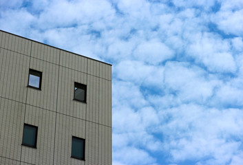 Fototapeta premium modern skyscraper with copy space cloudy blue sky as background.