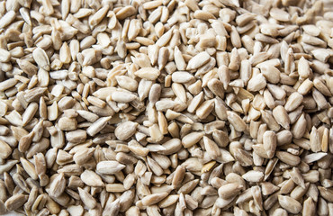 Raw food. Close up of seed for sunflower on white wooden background.