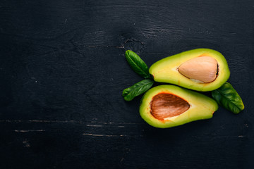 Avocado on a wooden background. Top view. Free space for your text.